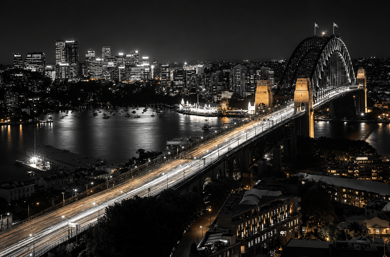Sydney Harbour Bridge illuminated at night with the city skyline reflecting on the water